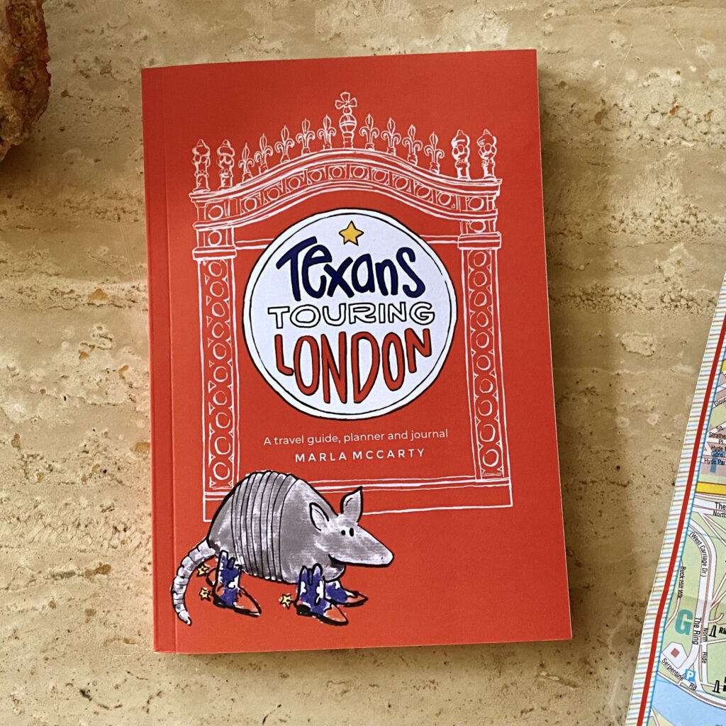 The book Texans Touring LONDON waiting to be picked up from atop a marble table.