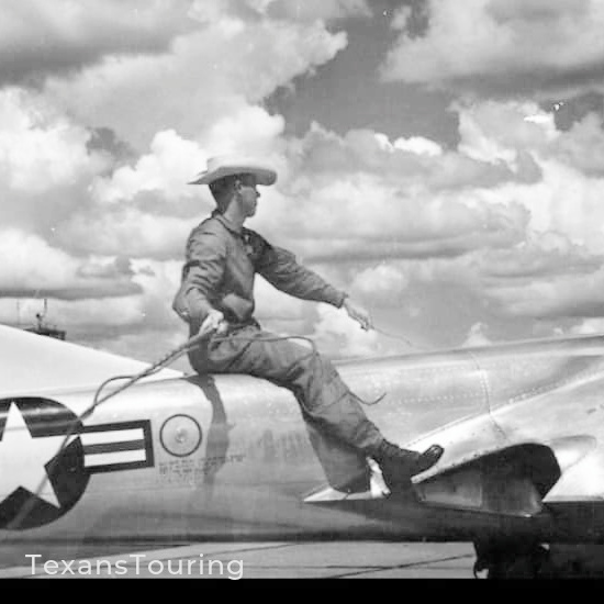 A vintage cowboy riding and roping atop a United States Air Force jet fighter.